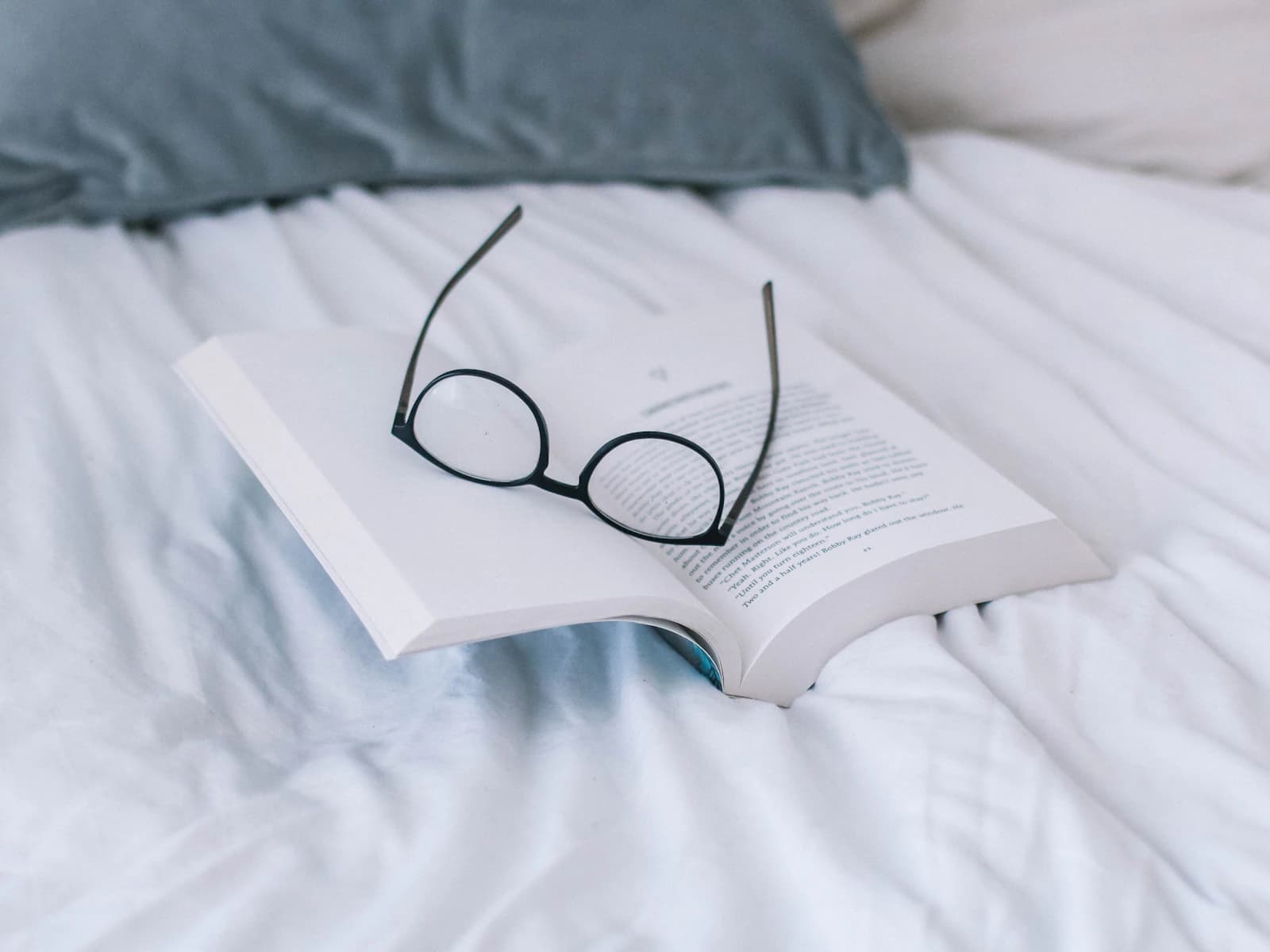 Reading glasses on an open book illustrating when to upgrade from reading glasses to progressive lenses