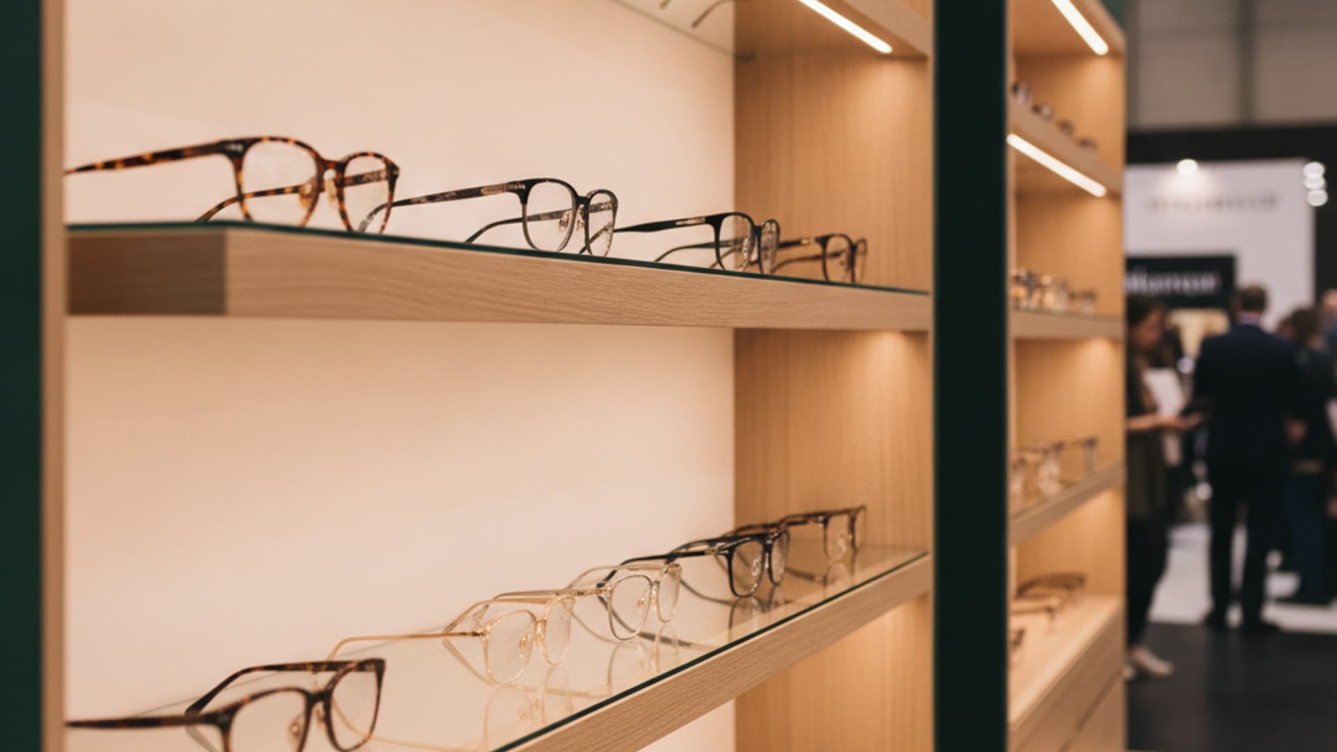 Upscale eyewear trade show exhibition booth with luxury frame displays and blurred conference floor